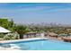 Refreshing pool with city views, a pristine patio, and elegant landscaping for an ultimate outdoor oasis at 2 Olympia Outlook Dr, Las Vegas, NV 89141
