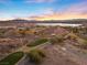 Aerial view of the community featuring a golf course and a distant lake and mountain backdrop at 20 Via Visione # 104, Henderson, NV 89011