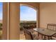 Inviting balcony showcasing outdoor seating and a stunning vista of the serene landscape at 20 Via Visione # 104, Henderson, NV 89011