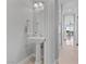 Neutral powder bath including pedestal sink with framed oval mirror at 20 Via Visione # 104, Henderson, NV 89011