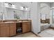 Bathroom with double sink vanity, tub, and modern tile accents at 20 Via Visione # 104, Henderson, NV 89011