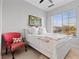 Bright bedroom featuring an accent chair with view out the window at 20 Via Visione # 104, Henderson, NV 89011