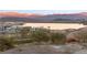 Scenic view of the community featuring a lake and mountain backdrop at sunset at 20 Via Visione # 104, Henderson, NV 89011
