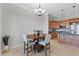 Dining area connected to kitchen with chandelier and view of kitchen stainless appliances at 20 Via Visione # 104, Henderson, NV 89011
