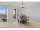 Bright dining room with a view of the lake through the french doors leading to the patio at 20 Via Visione # 104, Henderson, NV 89011