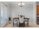 Cozy dining area with modern chandelier and view of the outdoors through sliding glass door at 20 Via Visione # 104, Henderson, NV 89011