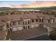 Aerial view of multi-unit townhouse featuring garages and brick driveway at 20 Via Visione # 104, Henderson, NV 89011