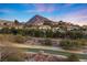 Upscale community homes sit hillside with a mountain backdrop and golf course in foreground at 20 Via Visione # 104, Henderson, NV 89011