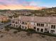 Gorgeous multi-Gathering home featuring a terracotta tile roof, balconies, and desert landscaping at 20 Via Visione # 104, Henderson, NV 89011