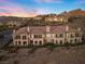Elevated view of residential building exterior with patios and desert landscaping at 20 Via Visione # 104, Henderson, NV 89011