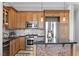 Modern kitchen with stainless steel appliances, granite counters, and custom cabinets at 20 Via Visione # 104, Henderson, NV 89011