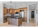 Traditional kitchen with stainless appliances, island with granite counters and tile backsplash at 20 Via Visione # 104, Henderson, NV 89011
