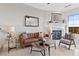Cozy living room with fireplace, leather couch, chair and lots of natural light at 20 Via Visione # 104, Henderson, NV 89011