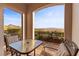 Outdoor patio with view of mountains, mature landscaping, table and chairs, and animal statues at 20 Via Visione # 104, Henderson, NV 89011