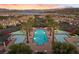 Aerial view of a luxurious pool with palm trees and nearby community buildings at 20 Via Visione # 104, Henderson, NV 89011