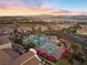 Aerial view of a community pool with cabanas, hot tub, palm trees and nearby housing at 20 Via Visione # 104, Henderson, NV 89011