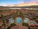 Aerial view of community pool featuring luxury amenities, a pool, palms and cabanas at 20 Via Visione # 104, Henderson, NV 89011