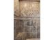 Close-up of tile shower with built in seat and metal hardware in neutral earth tones at 20 Via Visione # 104, Henderson, NV 89011