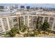 An aerial view of the condo building, mature landscaping, and surrounding city skyline in this amazing location at 205 E Harmon Ave # 409, Las Vegas, NV 89169
