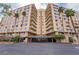 A luxury condo building featuring multi-story living with large balconies and mature tropical landscaping in a secure and welcoming setting at 205 E Harmon Ave # 409, Las Vegas, NV 89169