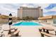 Relax and unwind at the community pool with lounge seating and table sets in this resort-style community at 205 E Harmon Ave # 409, Las Vegas, NV 89169
