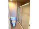 Bathroom with a standard toilet and shower with sliding doors, set against a neutral-toned tile floor at 270 E Flamingo Rd # 214, Las Vegas, NV 89169