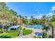 Meridian community view of a pool area with cabanas, lounge chairs, and lots of palm trees at 270 E Flamingo Rd # 214, Las Vegas, NV 89169
