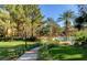 Landscaped Meridian community with a walkway through the lawn leading to the community pool at 270 E Flamingo Rd # 214, Las Vegas, NV 89169