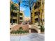 Condominium complex exterior view with palm trees, landscaping, and entrance stairs at 270 E Flamingo Rd # 214, Las Vegas, NV 89169
