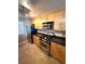 A kitchen with stainless steel appliances, light wood cabinets, and tile flooring is clean and stylish at 270 E Flamingo Rd # 214, Las Vegas, NV 89169
