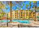 Resort style community pool with multiple lounge chairs and landscaping at 270 E Flamingo Rd # 214, Las Vegas, NV 89169