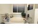Corner bathtub area with a tub, tile surround, and neutral decor at 2701 Brookstone Ct, Las Vegas, NV 89117