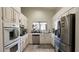 Well-lit kitchen with stainless steel appliances, ample counter space, and white cabinets at 2701 Brookstone Ct, Las Vegas, NV 89117