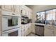 Functional kitchen featuring white cabinets, modern appliances, and a bright window above the sink at 2701 Brookstone Ct, Las Vegas, NV 89117