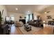 Spacious living area featuring a fireplace, comfortable seating, hardwood floors, and contemporary decor at 2701 Brookstone Ct, Las Vegas, NV 89117