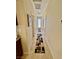 Long hallway with neutral walls and patterned rug at 2707 Chinaberry Hill St, Laughlin, NV 89029