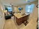 Open concept kitchen with granite countertops, stainless steel appliances, and breakfast bar overlooking the living room at 2707 Chinaberry Hill St, Laughlin, NV 89029
