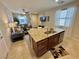 Kitchen with granite countertops, stainless steel appliances, and island with breakfast bar overlooking the living room at 2707 Chinaberry Hill St, Laughlin, NV 89029