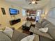 An open-concept living room featuring neutral tones and an adjacent kitchen at 2707 Chinaberry Hill St, Laughlin, NV 89029