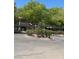 The exterior of the building features mature trees and well manicured bushes at 2713 Otter Creek Ct # 202, Las Vegas, NV 89117