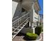 Exterior view of a two story condo building with white stucco and access stairs to upper units at 2713 Otter Creek Ct # 202, Las Vegas, NV 89117