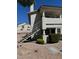 Exterior view of a two story condo building with white stucco and access stairs to upper units at 2713 Otter Creek Ct # 202, Las Vegas, NV 89117