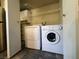 A convenient laundry room featuring a washer, dryer, shelving, and storage cabinets at 2750 S Durango Dr # 1038, Las Vegas, NV 89117