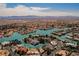 Stunning aerial view of waterfront homes, a golf course, and mountains in a lakeside planned community at 2805 High Sail Ct, Las Vegas, NV 89117