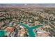 Breathtaking aerial perspective of homes nestled along a serene body of water with city and mountain views at 2805 High Sail Ct, Las Vegas, NV 89117