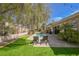 Wide angle view of the backyard, pool, spa, outdoor patio, green space and mature landscaping at 2805 High Sail Ct, Las Vegas, NV 89117