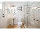 Well-lit bathroom featuring a pedestal sink, toilet, and a modern glass-enclosed shower for a spa-like experience at 2805 High Sail Ct, Las Vegas, NV 89117