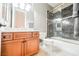 Bathroom features a wood vanity cabinet and a shower-bathtub combination with black marble-style tile surround at 2805 High Sail Ct, Las Vegas, NV 89117