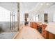 Luxurious bathroom with dual sink vanity, glass enclosed shower, and tile floors at 2805 High Sail Ct, Las Vegas, NV 89117