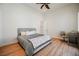 Comfortable bedroom with hardwood floors, natural light, a modern ceiling fan, and a dedicated desk area at 2805 High Sail Ct, Las Vegas, NV 89117
